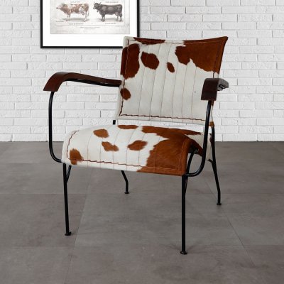Bruin/witte fauteuil van echt koeienhuid